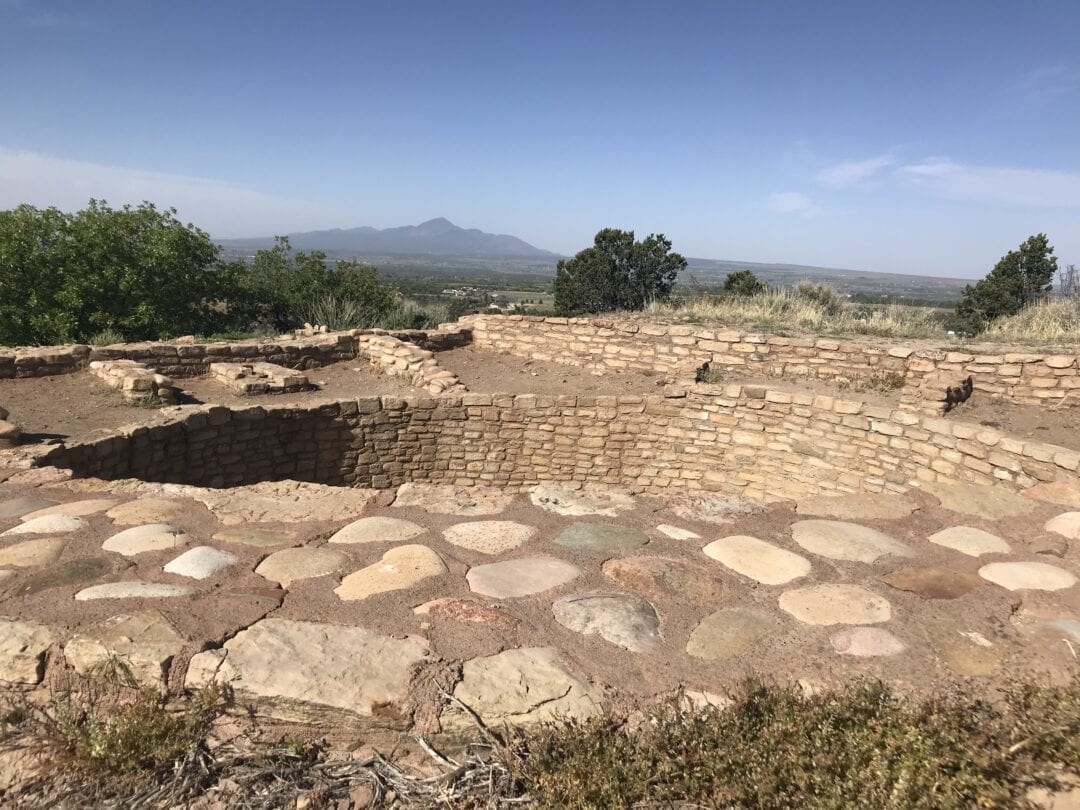 Stones pave the way to a circular opening in the ground.