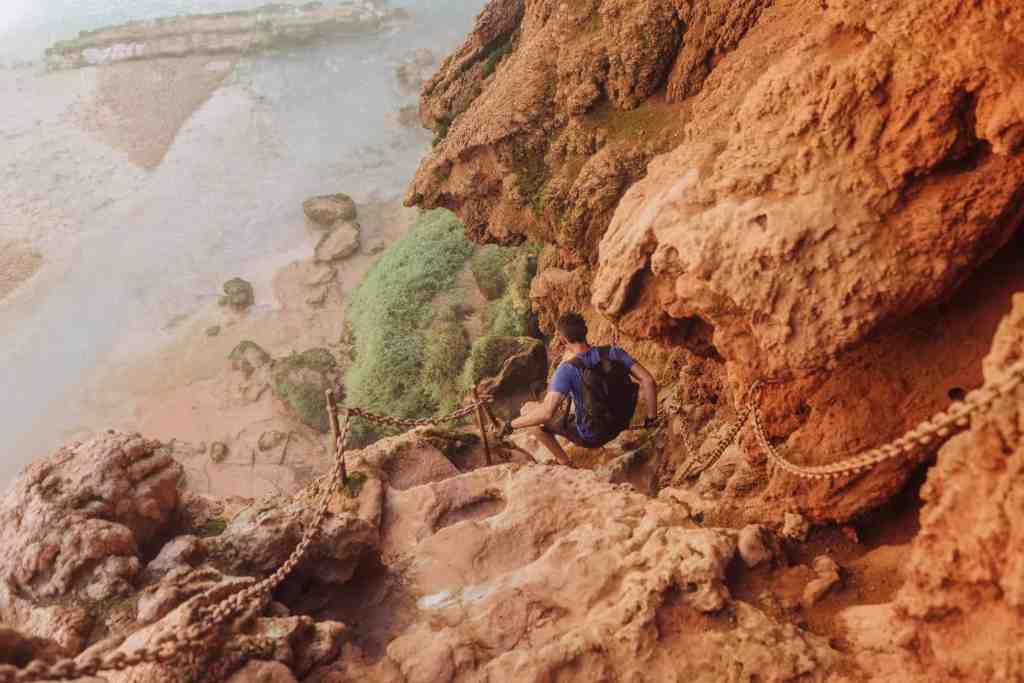 climbing down Mooney Falls rocks