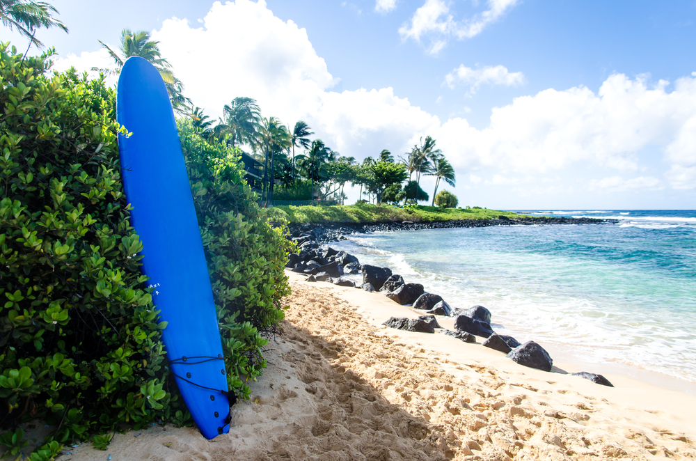 Surfboard on the sandy Poipu beach in Hawaii, Kauai