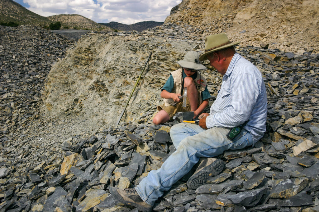 A man and a boy digging for fossil at U-Dig Fossils Quarry